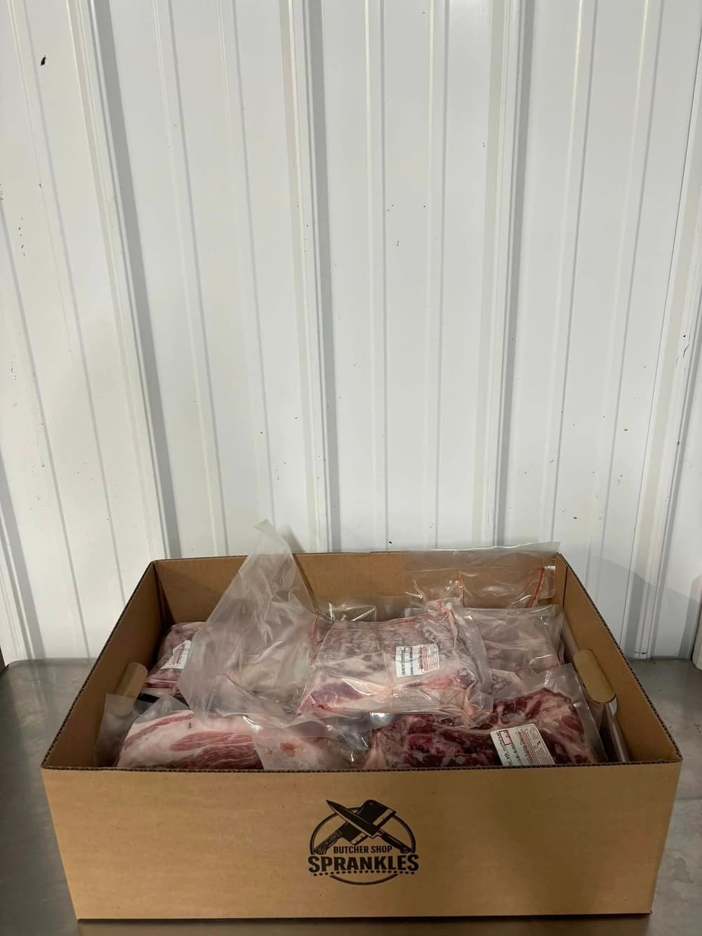A Sprankle's box packed with vacuum sealed and labeled cuts